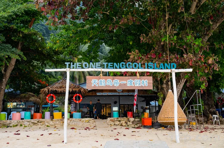 Beachfront entrance to The One Tenggol Island Resort with a hanging swing chair