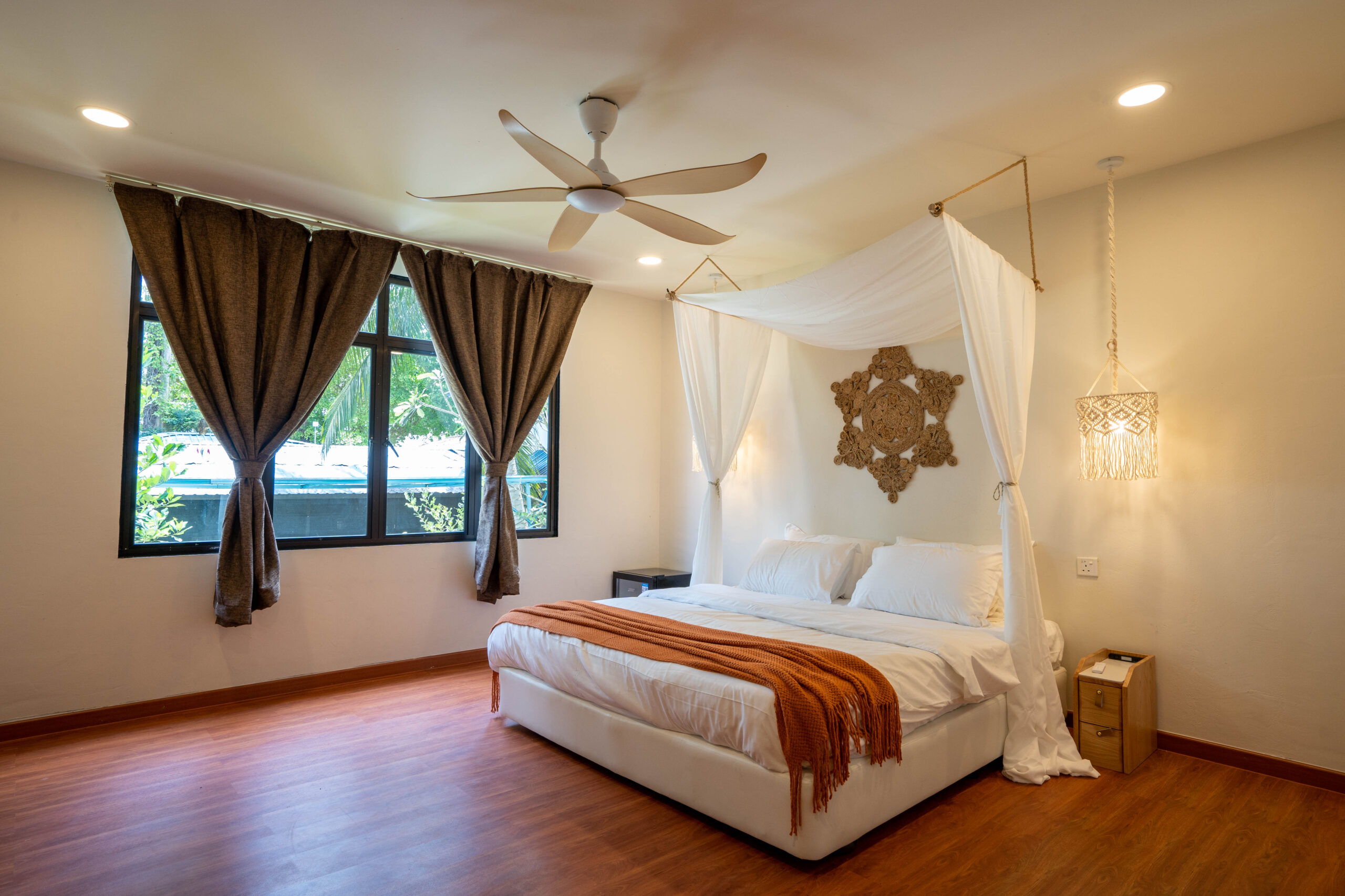 Deluxe double bedroom interior with canopy bed and warm wood floors